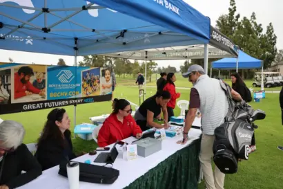 Golfers checking in at the registration tables beside the Boys & Girls Club of Huntington Valley banners